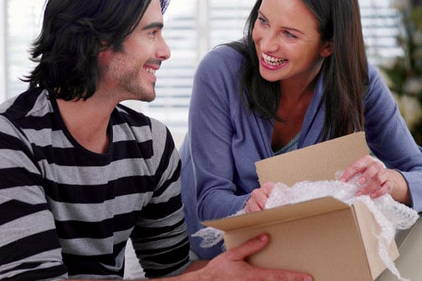 Couple packing a cardboard box