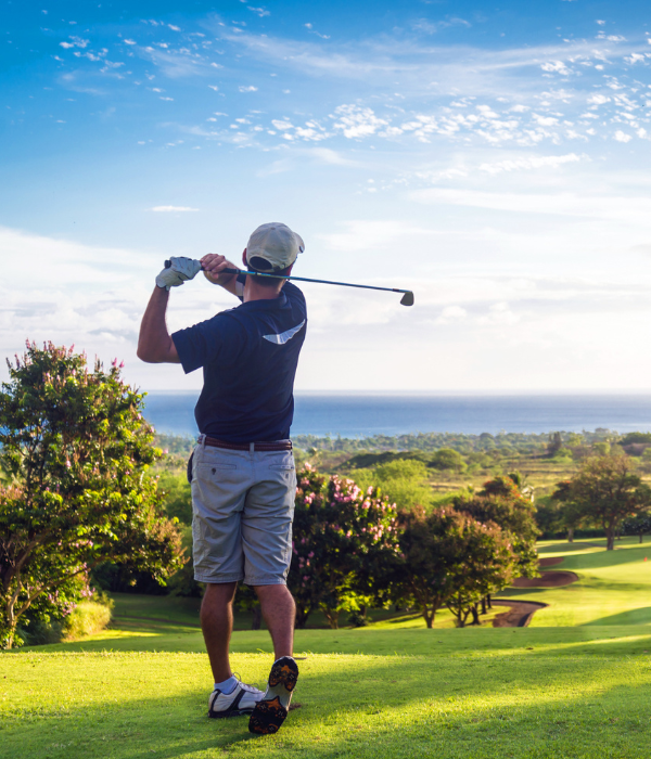 Golfer on a golf course overlooking the sea
