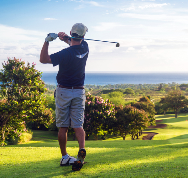 Golfer on a golf course overlooking the sea