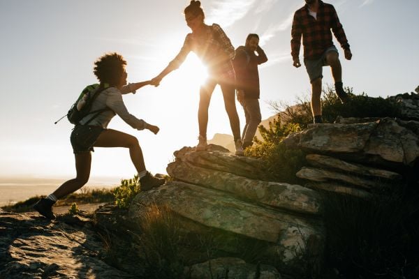 Young people climbing a mountain