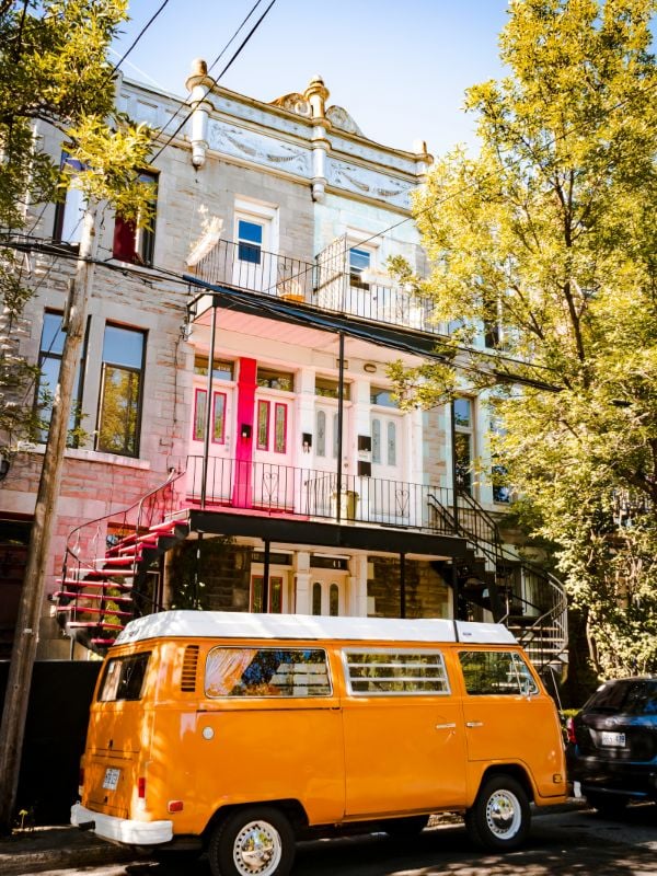 Camper van outside a colourful house in Montreal