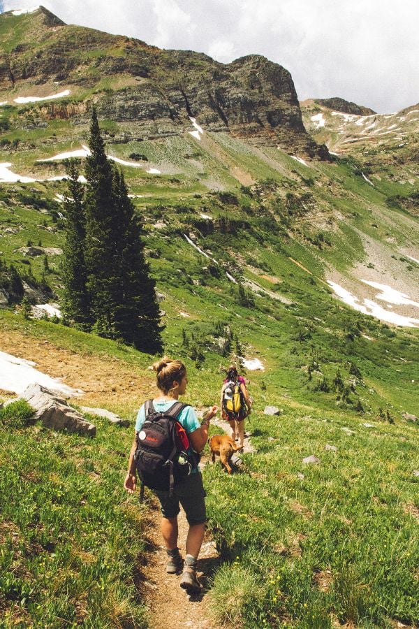 Two women hiking down a mountain