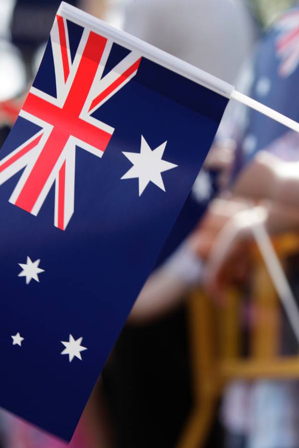 Person holding a small Australian flag
