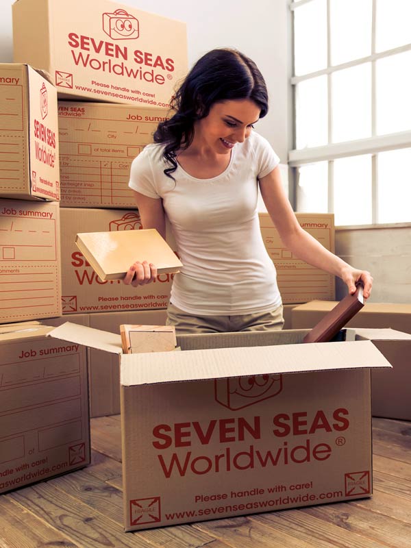 Woman packing shipping boxes