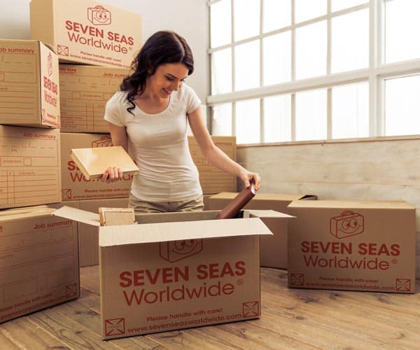 Woman packing shipping boxes