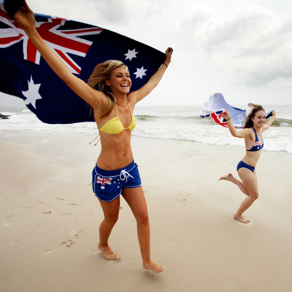 Women on the beach holding the Australia flag