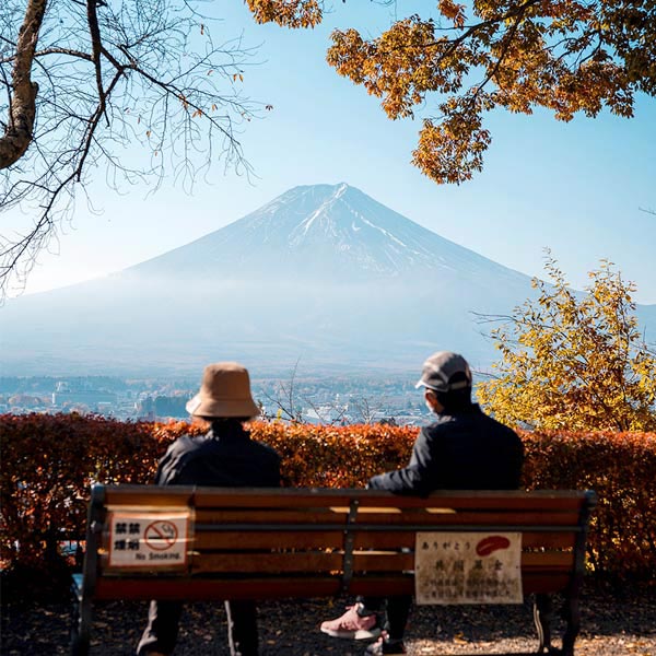 Couple sitting on a bench overlooking Mount Fuji in Japan