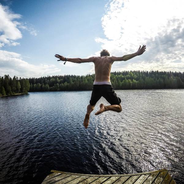 Man jumping into a lake in Finland