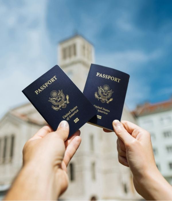 Two hands holding United States passports