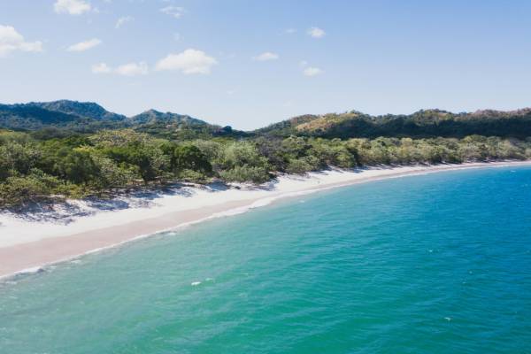 Sandy beach beside a blue sea in Costa Rica