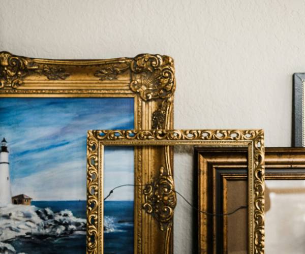 A row of art and frames against a wall