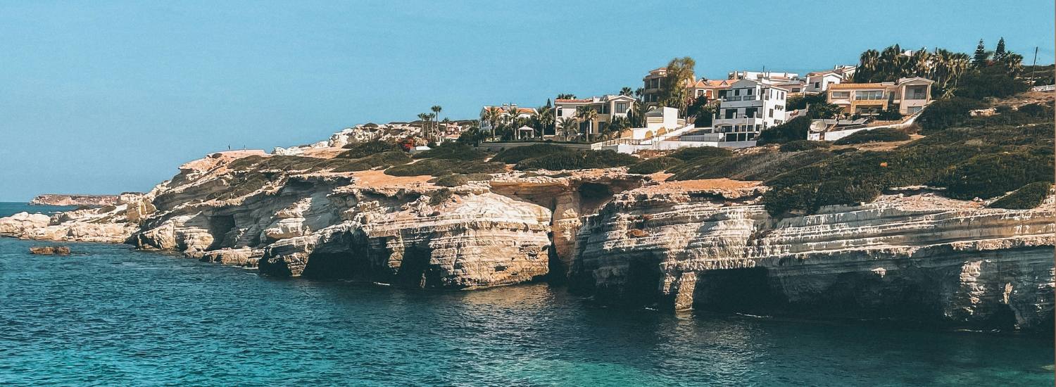 Brown rocky shore with blue water during daytime Cyprus