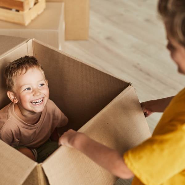 Smiling child in a cardboard box