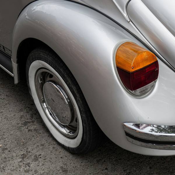 Close up of a car wheel and rear light