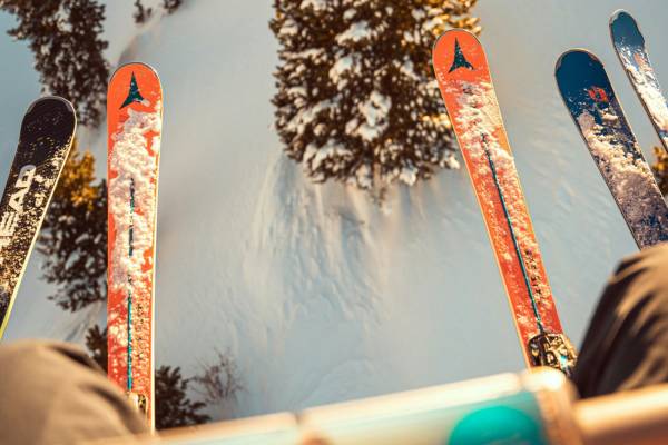 People's feet wearing skis hanging from a chairlift