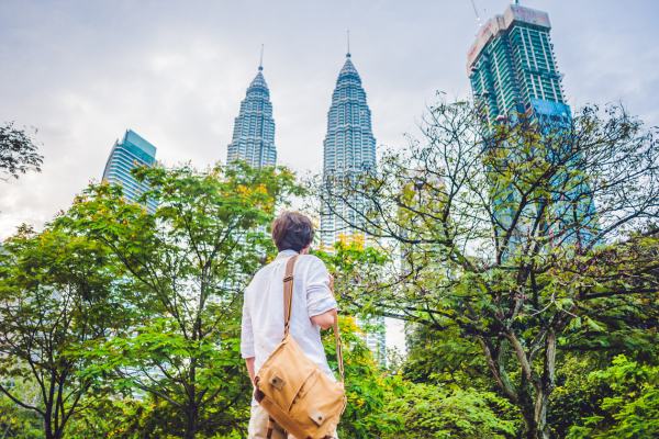 Tourist in Malaysia looking up at the Petronas Twin Towers