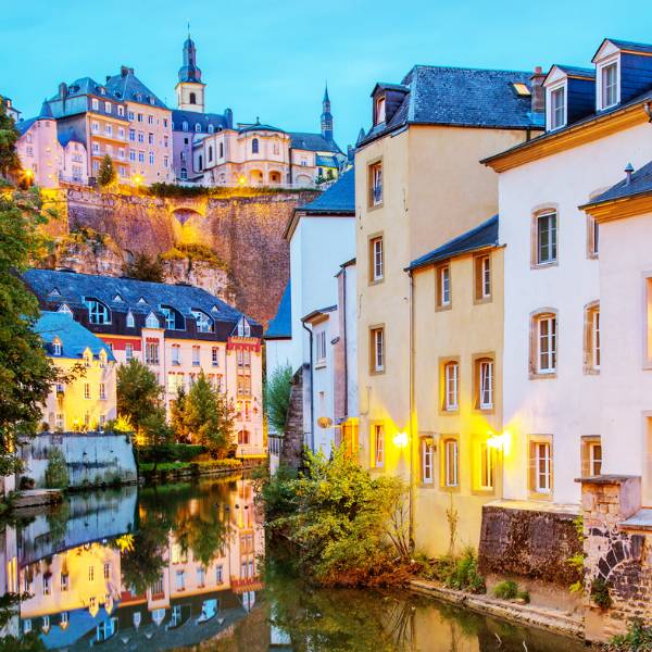 Houses beside a river in Luxembourg at dusk