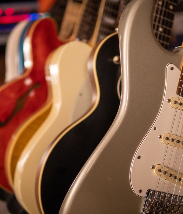 Close up of a rack of electric guitars