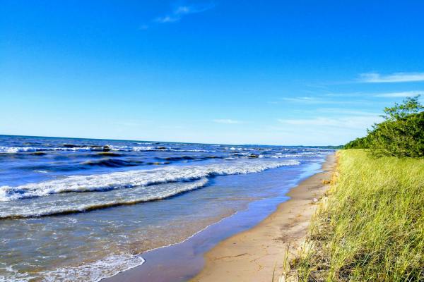 Blue water lapping a sandy beach in Michigan
