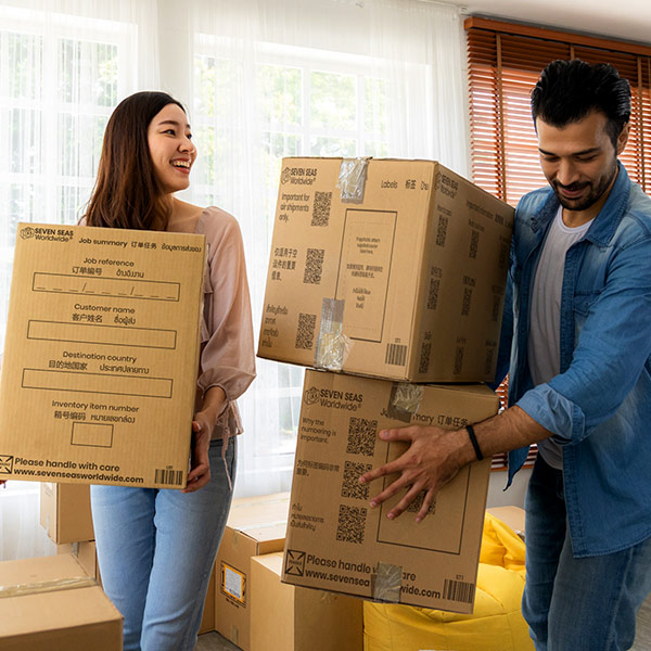 Couple moving cardboard boxes