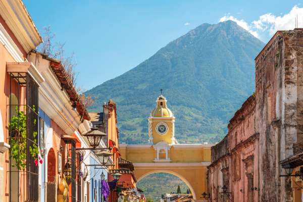 Colourful buildings against a mountain in Antigua and Barbuda