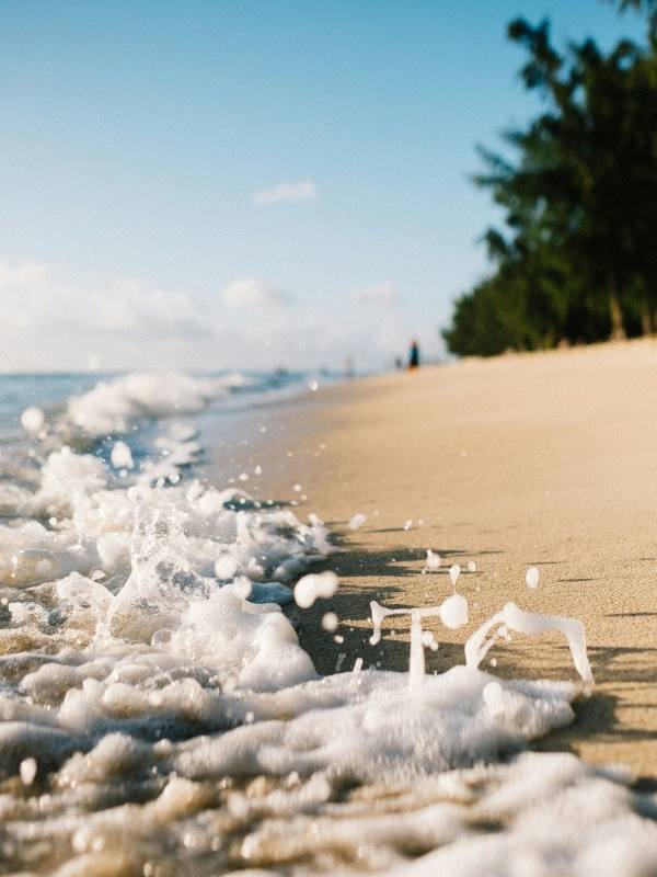Close-up of surf lapping a sandy shore in Mauritius 