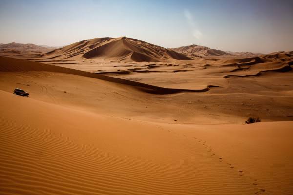 A jeep crossing sand dunes in Oman