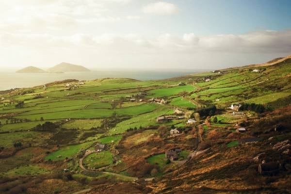 Rolling green hills next to the sea in Ireland