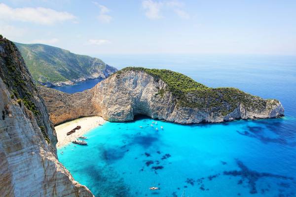 Sandy cove and cliff face above a bright blue sea in the Virgin Islands