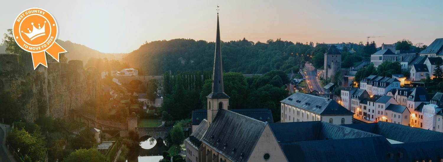 Luxembourg city at dusk with best country to move to badge 