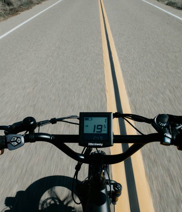 Close-up of a speedometer on an electric bike travelling down a road