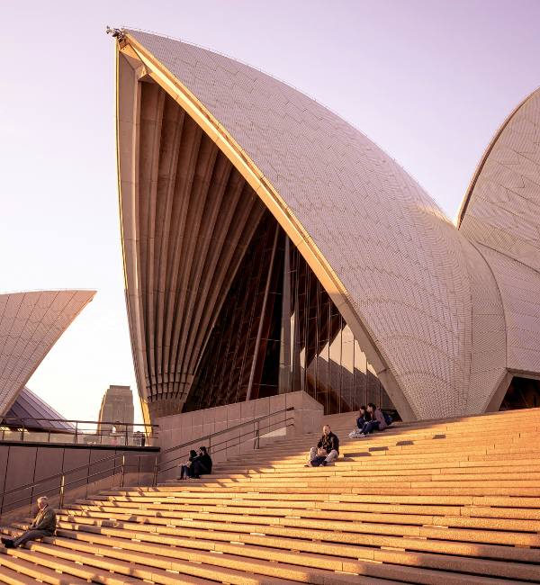People sat on steps outside Sydney Opera House in Australia