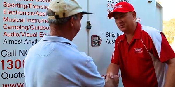 Seven Seas Worldwide team member greeting a customer beside a removals vehicle in Australia